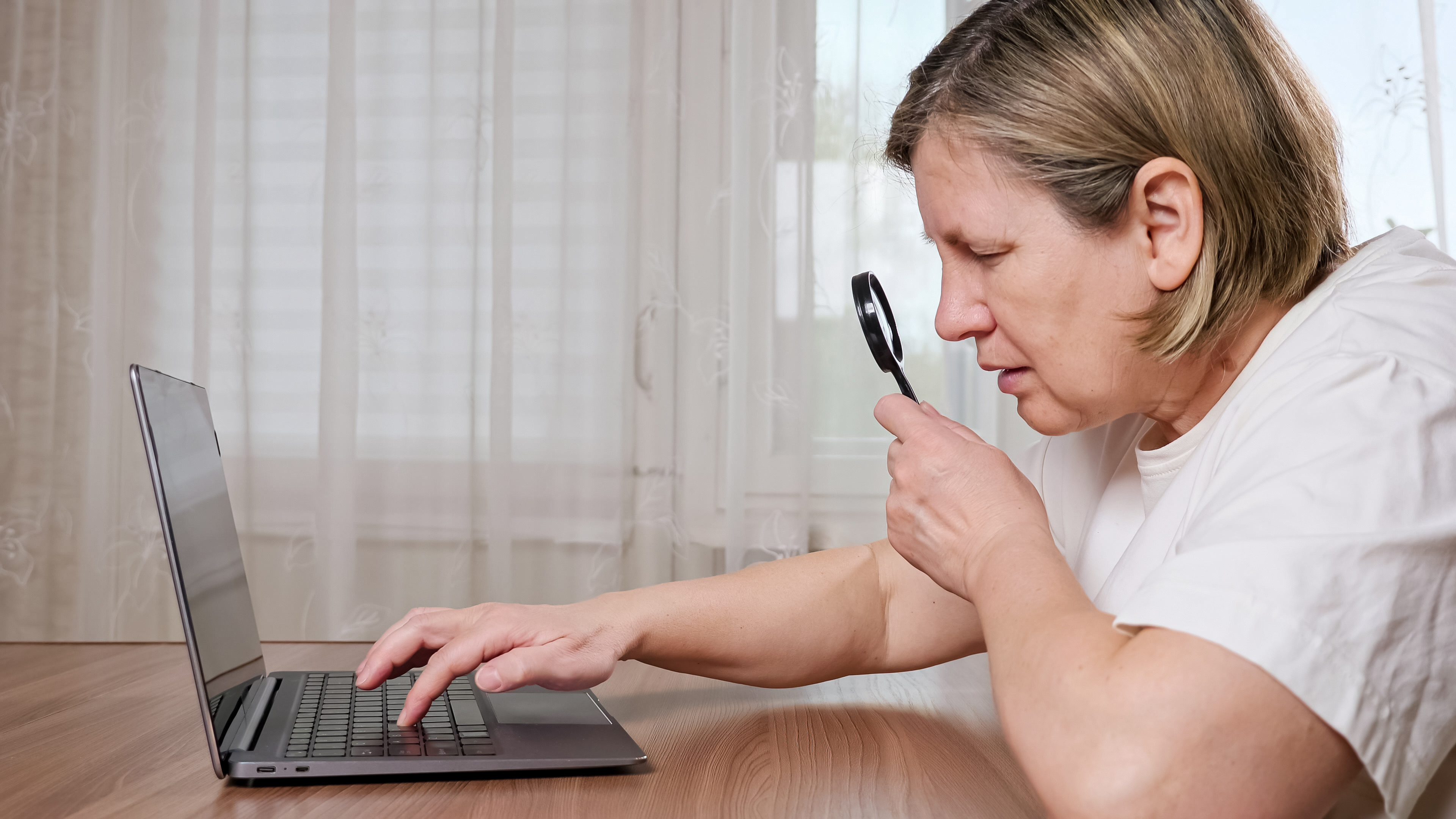 Woman viewing data through a magnifying glass 